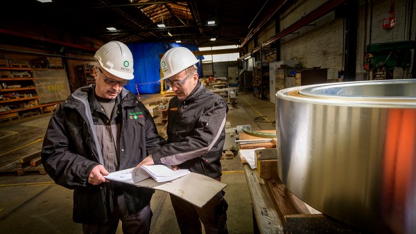 Peter Fischer, employee from Schaeffler’s plant in Schweinfurt, Germany (pictured left) and Gerard Versteeg, from Schaeffler Netherlands (pictured right) during the installation of the new bearings in the 67 pulleys of the “Botlek” vertical-lift bridge.