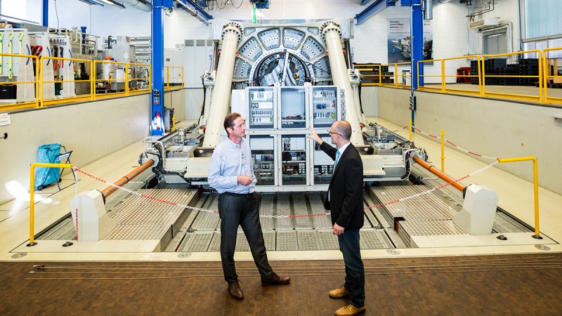 Andreas Mangold (right) in front of the large-size bearing test rig Astraios. With its realistic force and torque simulation, Astraios has been providing valuable results, which are used for the new development of bearing solutions.