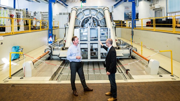 Andreas Mangold (right) in front of the large-size bearing test rig Astraios. With its realistic force and torque simulation, Astraios has been providing valuable results, which are used for the new development of bearing solutions.